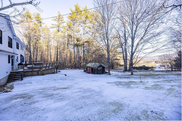 yard covered in snow featuring a wooden deck