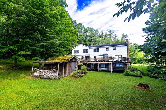 back of property with a lawn and a deck