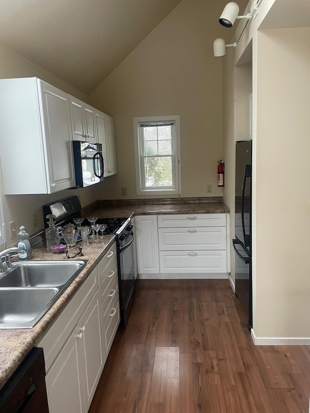 kitchen with sink, white cabinets, lofted ceiling, dark hardwood / wood-style floors, and black appliances