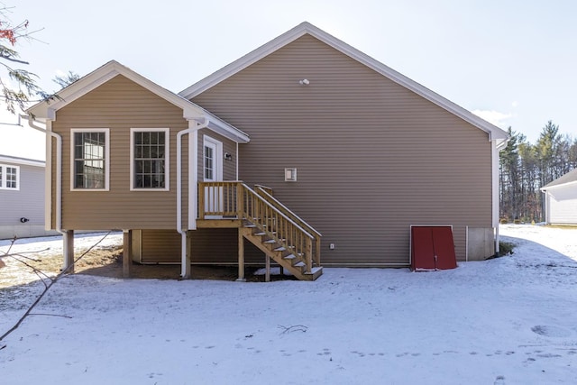 view of snow covered back of property