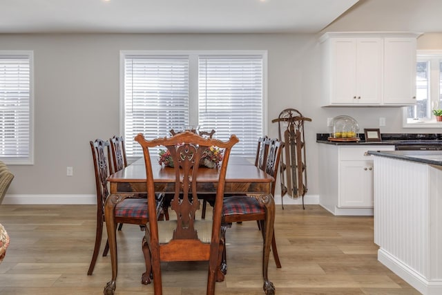 dining room featuring plenty of natural light and light hardwood / wood-style flooring