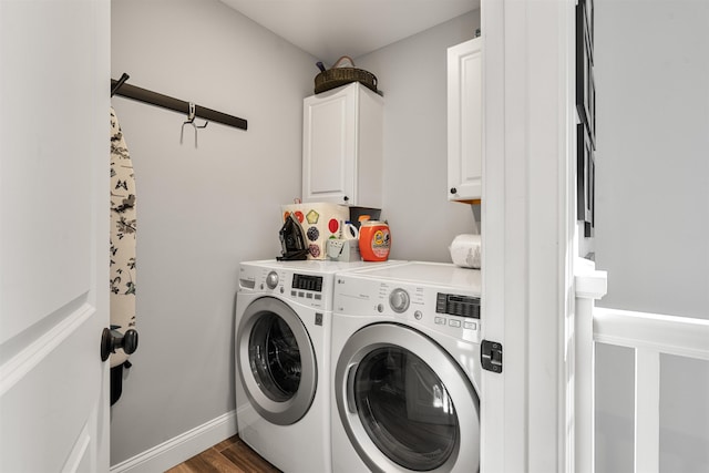 clothes washing area featuring separate washer and dryer, cabinets, and dark hardwood / wood-style floors