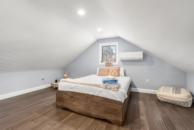 bedroom featuring a wall mounted AC, vaulted ceiling, and dark wood-type flooring