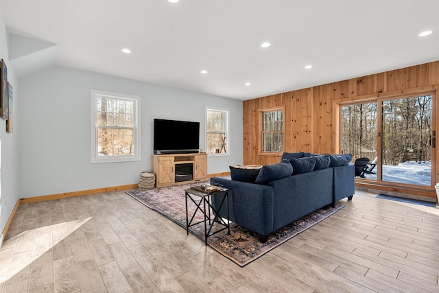 living room featuring wood walls and light hardwood / wood-style flooring