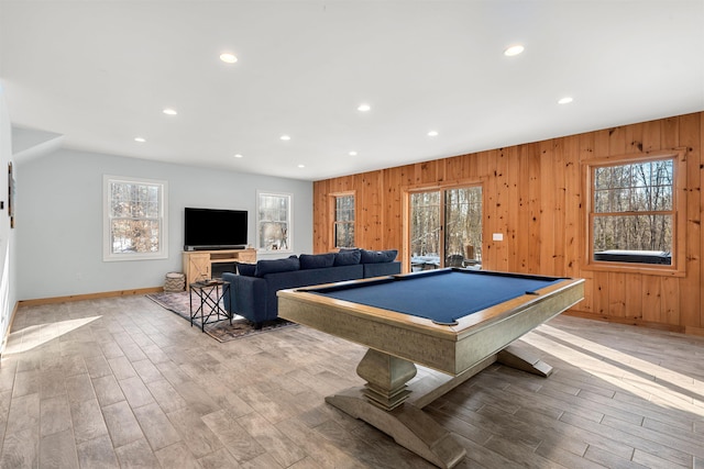 rec room featuring pool table, light wood-type flooring, wooden walls, and a wealth of natural light