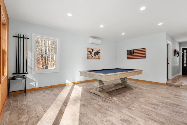 game room with billiards, light hardwood / wood-style flooring, and a wall mounted AC