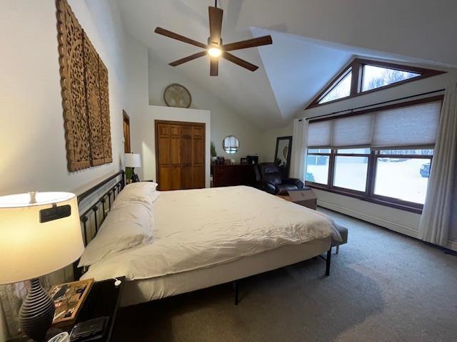 carpeted bedroom featuring ceiling fan and vaulted ceiling