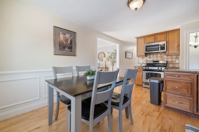 dining space with light hardwood / wood-style flooring