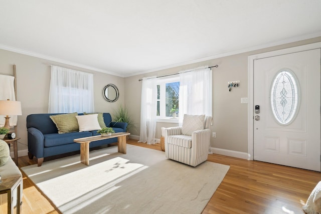 living room with light wood-type flooring and ornamental molding