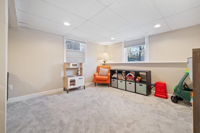 game room featuring a paneled ceiling and carpet