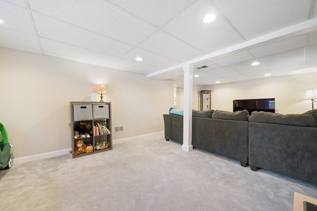 carpeted living room featuring a paneled ceiling