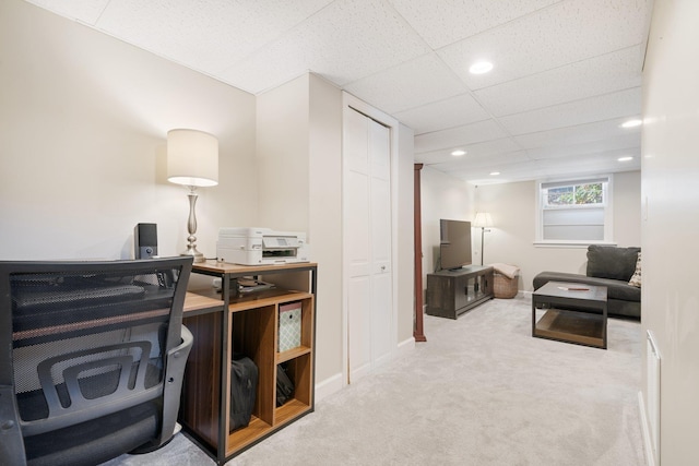 carpeted office featuring a drop ceiling