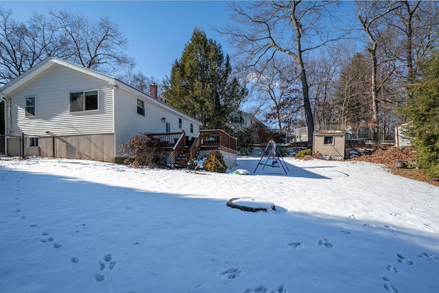 exterior space featuring a deck and a storage shed