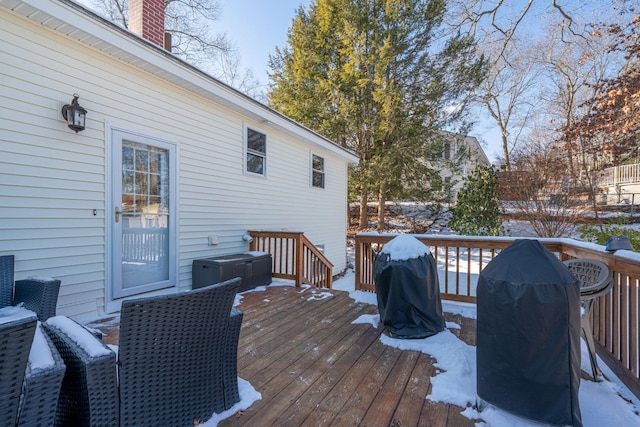 snow covered deck featuring a grill