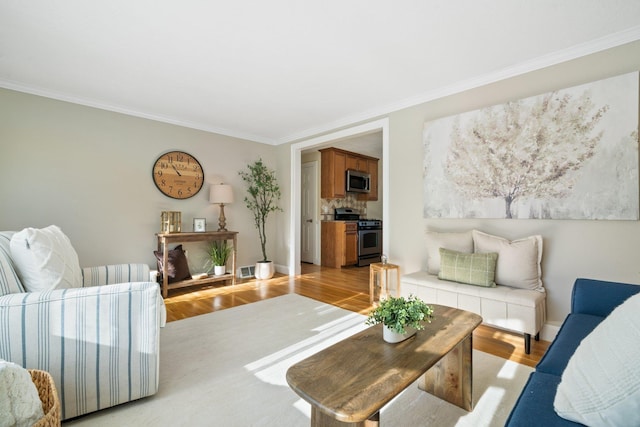 living room featuring light hardwood / wood-style floors and ornamental molding