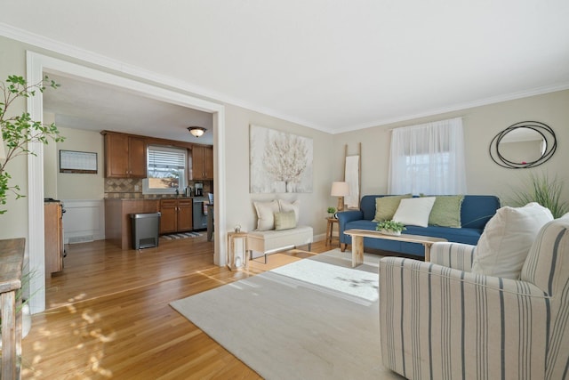 living room with light hardwood / wood-style floors and crown molding