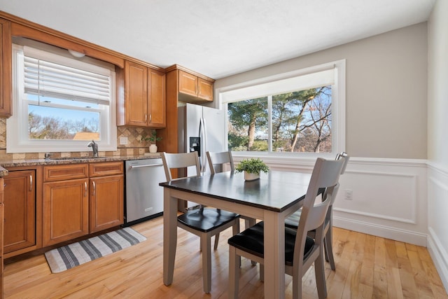 dining area featuring light wood-type flooring and sink