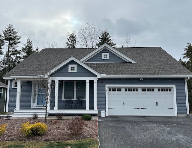 view of front of house featuring a porch and a garage