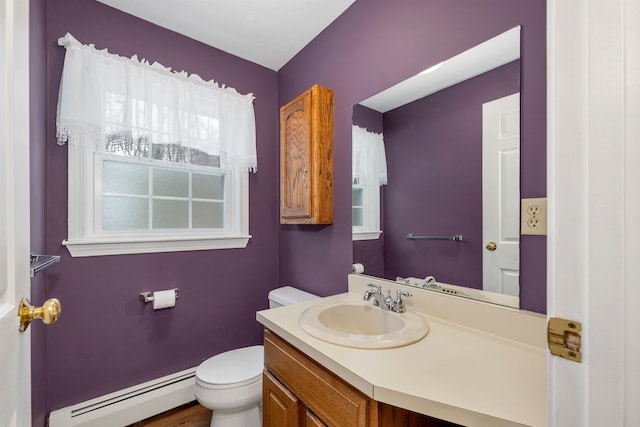 bathroom with a baseboard radiator, vanity, and toilet