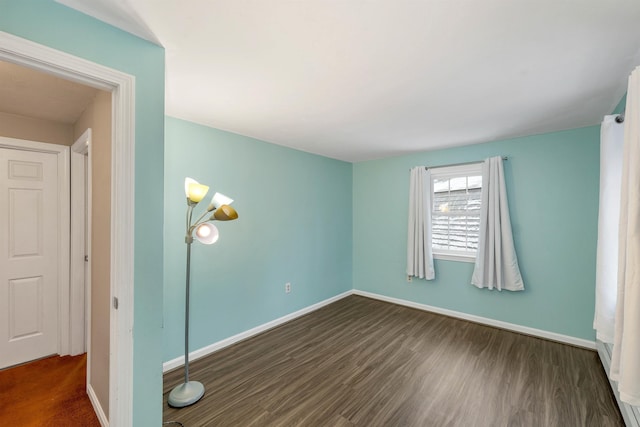 empty room featuring dark wood-type flooring