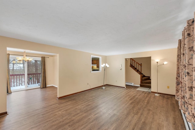 unfurnished room featuring a baseboard radiator, a chandelier, and hardwood / wood-style flooring