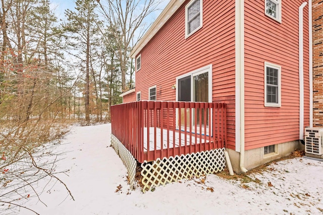 snow covered property featuring a deck