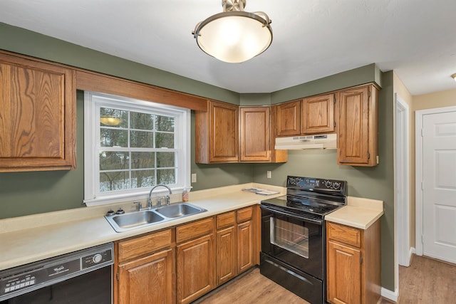 kitchen with light hardwood / wood-style flooring, black appliances, and sink