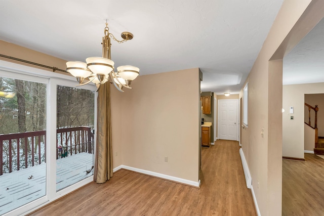 interior space with light hardwood / wood-style floors and a chandelier