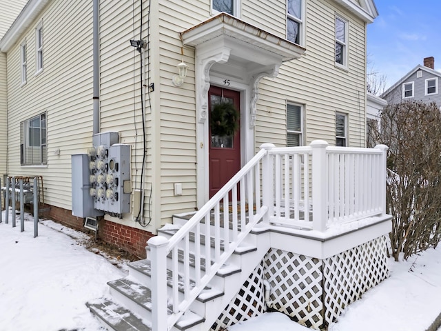 view of snow covered property entrance