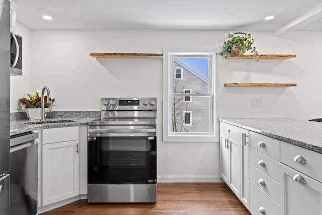 kitchen with stainless steel appliances, dark wood-type flooring, white cabinets, and sink