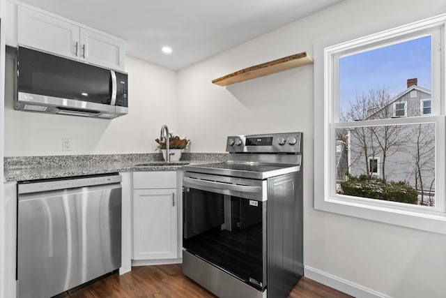 kitchen featuring stainless steel appliances, white cabinets, dark hardwood / wood-style flooring, and sink