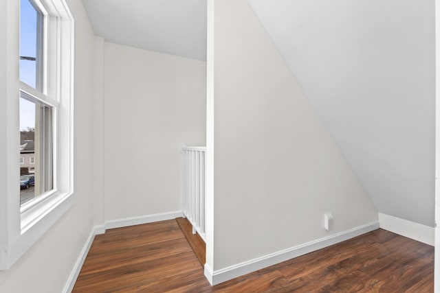 bonus room with dark wood-type flooring