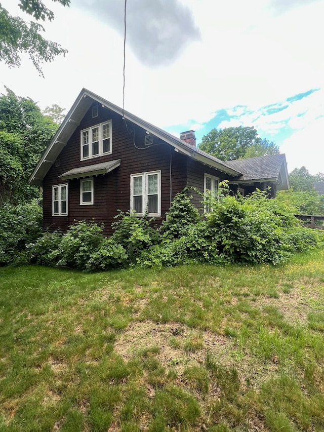 view of property exterior with a yard