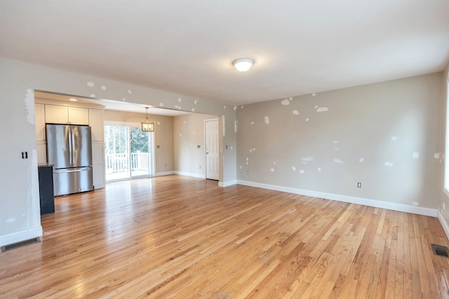 unfurnished living room with light wood-type flooring