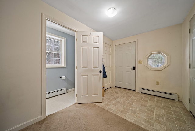 carpeted entrance foyer featuring a baseboard radiator