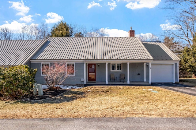 view of front of property with a porch, a front yard, and a garage