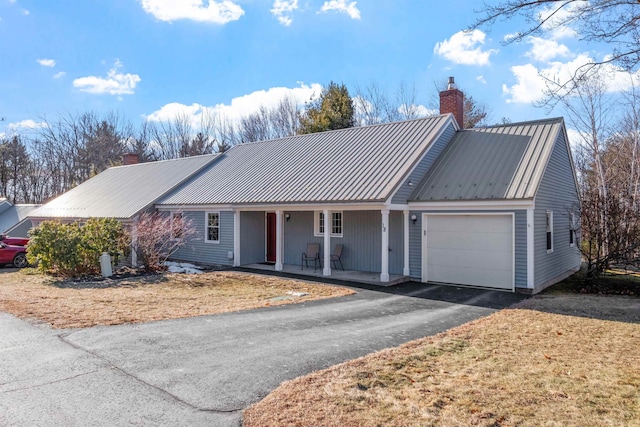 ranch-style home featuring covered porch and a garage