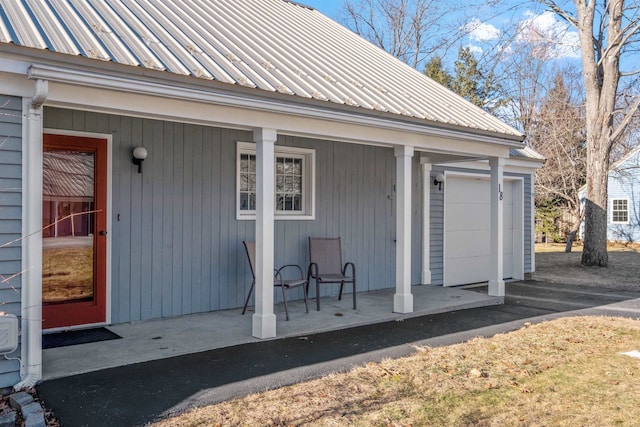 entrance to property with a garage and covered porch