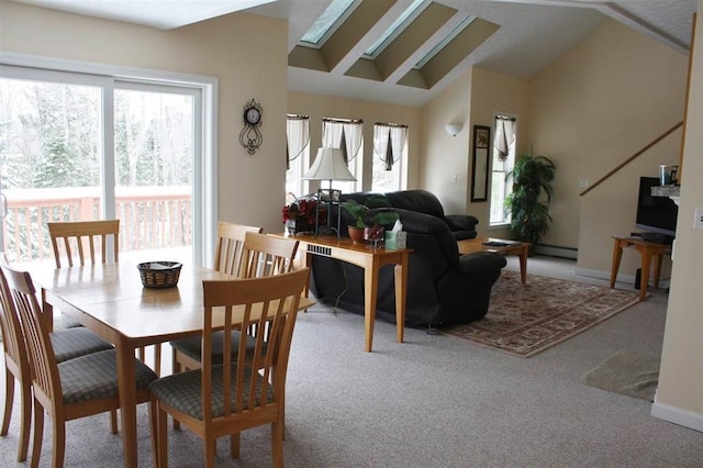 carpeted dining room featuring lofted ceiling and a baseboard radiator