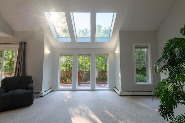 living room featuring a baseboard radiator and vaulted ceiling with skylight