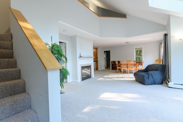 carpeted living room with a baseboard heating unit