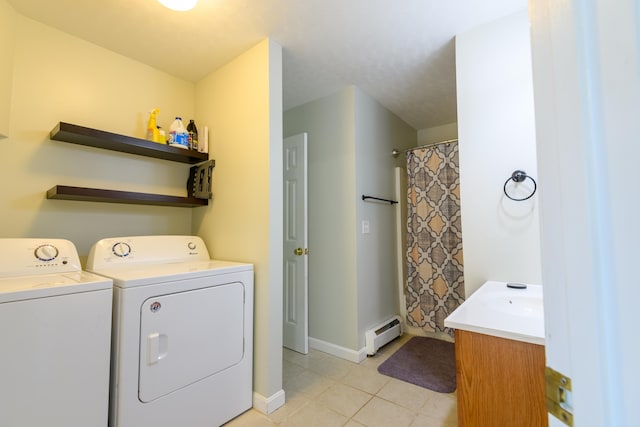 laundry area featuring sink, a baseboard radiator, washer and clothes dryer, and light tile patterned flooring