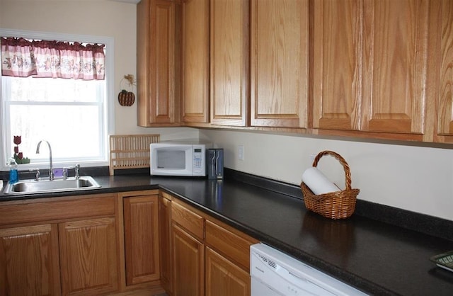 kitchen featuring sink and white appliances