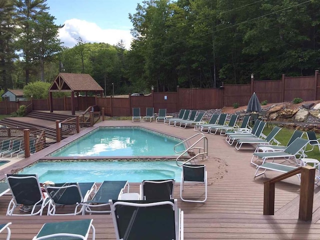 view of pool featuring a wooden deck and a gazebo