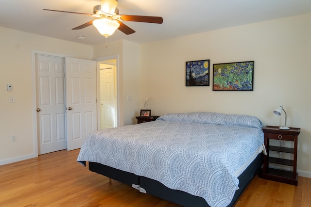 bedroom with ceiling fan and light hardwood / wood-style floors