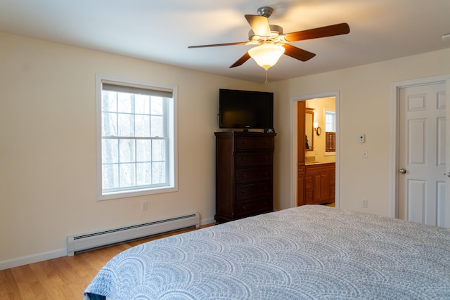 bedroom with ceiling fan, a baseboard radiator, light hardwood / wood-style floors, and connected bathroom