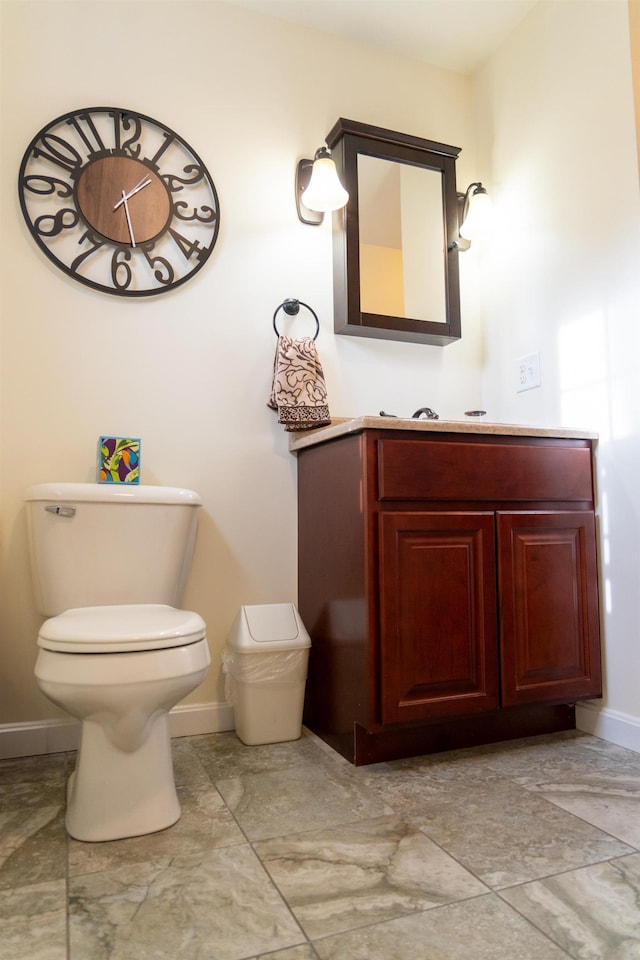 bathroom featuring toilet and vanity