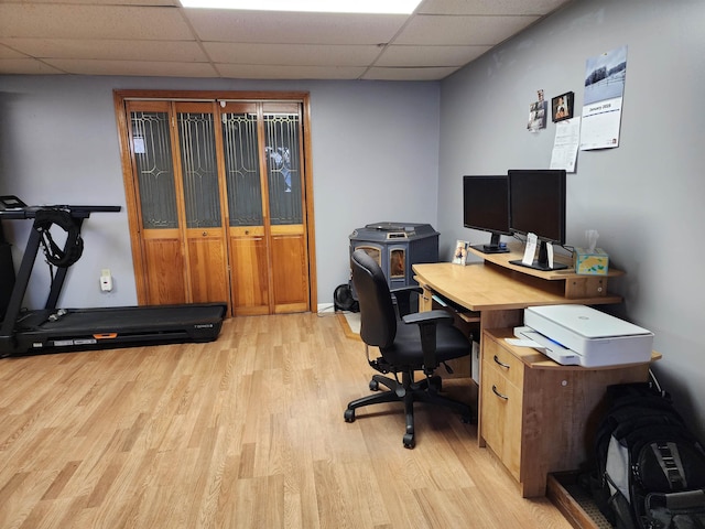 office area with light hardwood / wood-style floors and a drop ceiling