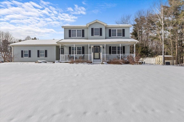 front of property featuring a porch and a storage unit