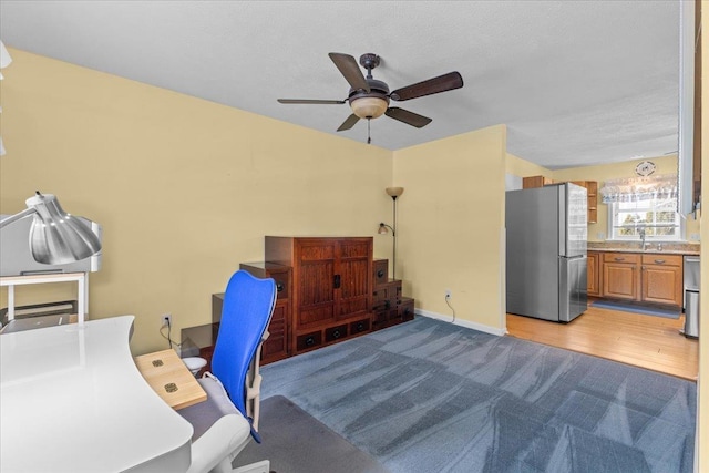 office with sink, ceiling fan, and light hardwood / wood-style floors